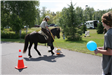 Mounted officer with broom and beach ball for obstacle course